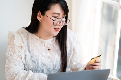Midsection of woman using mobile phone