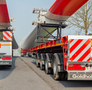 Red flags on road against sky in city