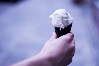 Cropped image of hand holding ice cream