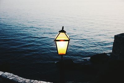 High angle view of illuminated lamp by sea