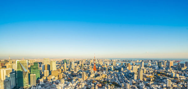 Aerial view of cityscape against clear sky during sunset