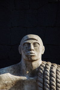 Close-up of statue against black backgrounds