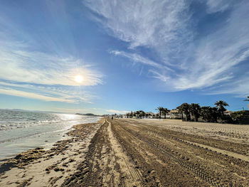 View of tire tracks on beach