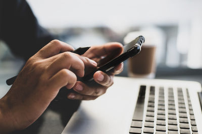 Midsection of man using laptop