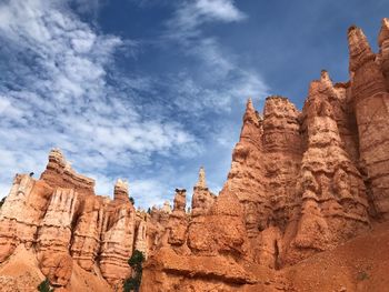 Low angle view of rock formations against sky