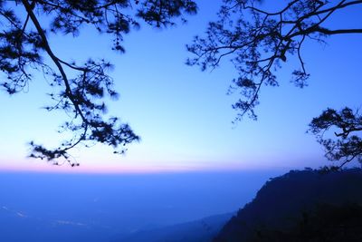 Scenic view of mountains against blue sky