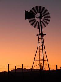 Low angle view of windmill at sunset