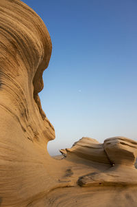 Low angle view of rock formation against clear sky