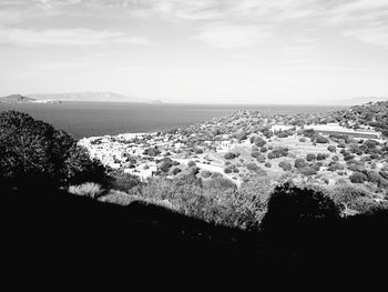 Scenic view of sea and town against sky