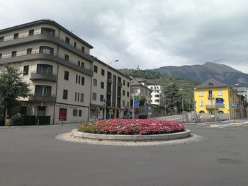 Street amidst buildings in city against sky