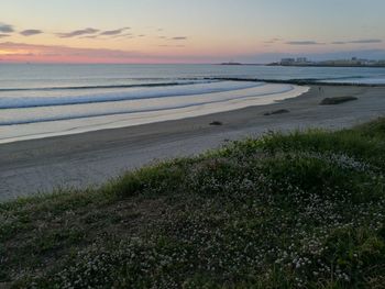 Scenic view of beach against sky during sunset