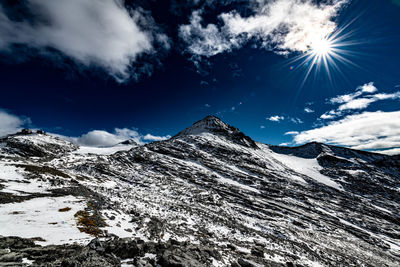 Low angle view of snowcapped mountains against sky