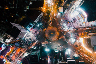 Digital composite image of illuminated city street and buildings at night