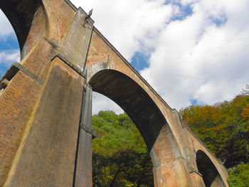 Low angle view of arch bridge against sky