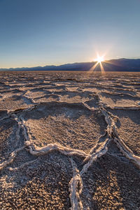 Last sun burst at the salt flats of badwater in death valley national park, california