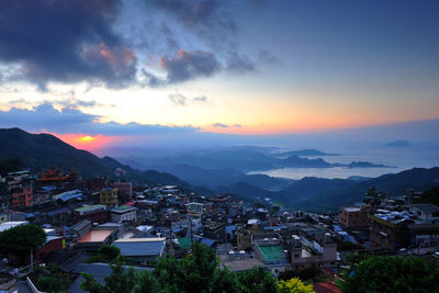 Aerial view of town against sky during sunset