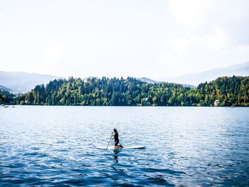 Man surfing on boat against sky