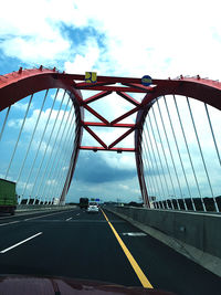 View of bridge against cloudy sky