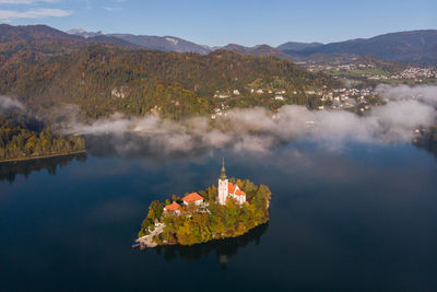 Panoramic view of lake and buildings against sky