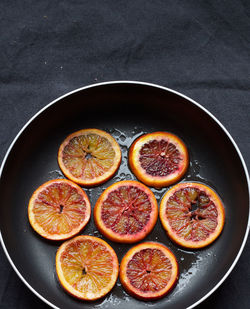 High angle view of caramelized blood orange slices in saucepan