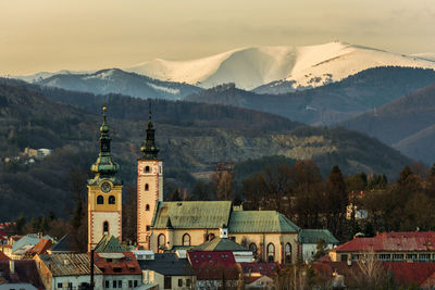 High angle view of townscape and mountains against sky