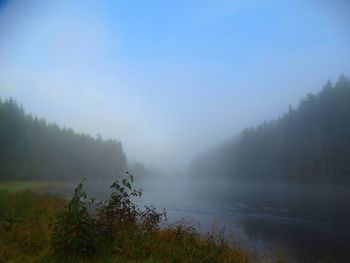 Scenic view of landscape against sky during foggy weather