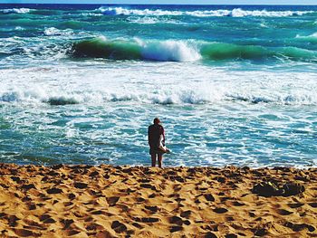 Rear view of man standing on beach