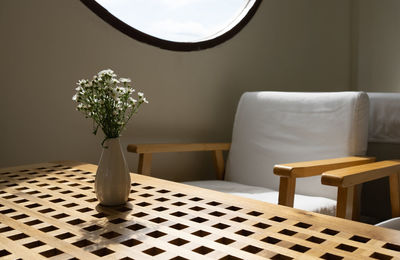 White flowers in vase on wooden table