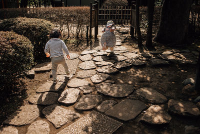 Two children running during the sunset