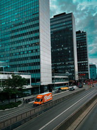 View of city street and buildings against sky