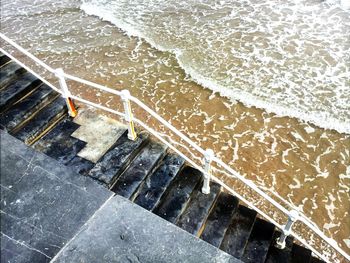 High angle view of staircase by sea at beach