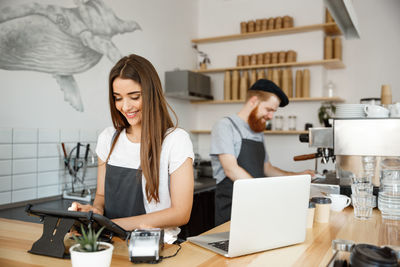 Young woman working with laptop in office