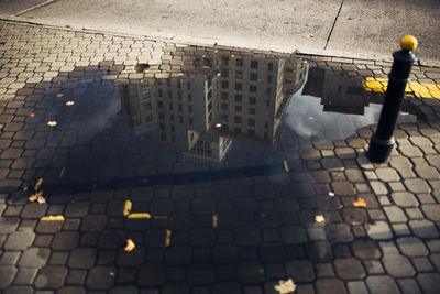 High angle view of sidewalk by street in city