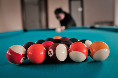 Close-up of man playing with ball on table