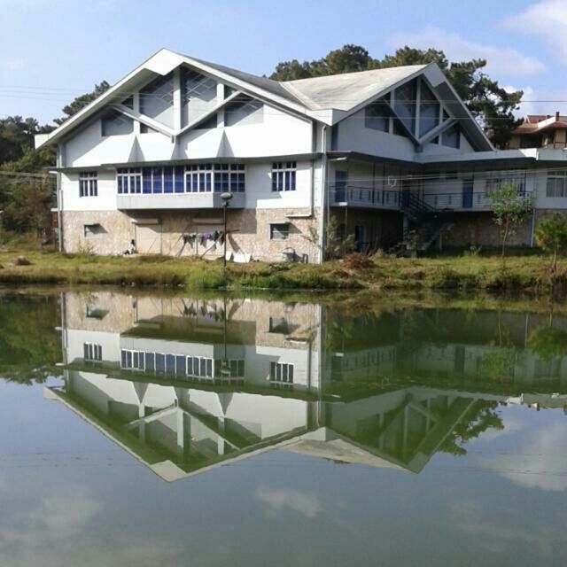 architecture, building exterior, built structure, reflection, water, house, tree, waterfront, residential structure, residential building, sky, lake, day, canal, window, standing water, building, outdoors, pond, no people