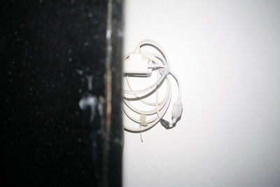 Close-up of light bulb against wall