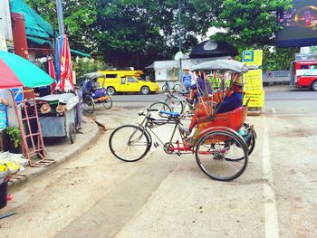 Bicycles on road against trees in city