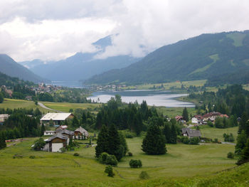 Scenic view of lake and mountains against sky