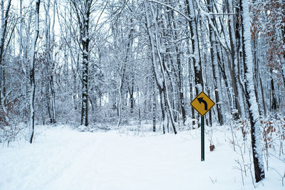 Road sign on snow covered land