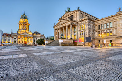 An empty gendarmenmarkt square in berlin just before sunrise