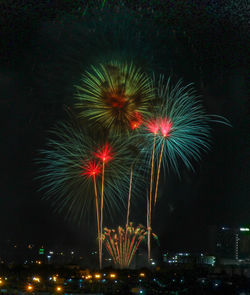 Firework display in city at night