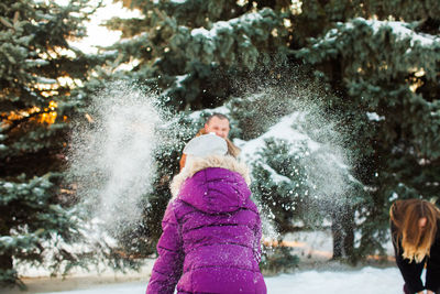 Full length of woman playing in park during winter