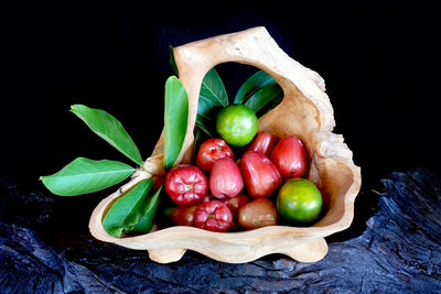 Directly above shot of fruits and leaves on table