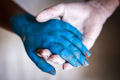 Close-up of hand holding blue ring