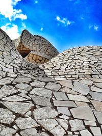 Low angle view of coliseum against blue sky