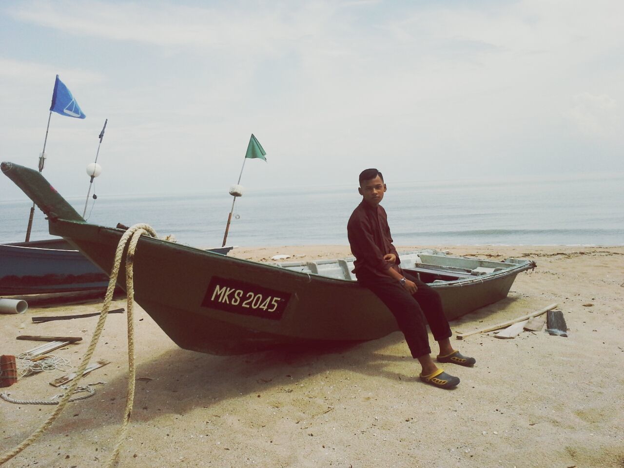 sea, horizon over water, beach, water, sky, shore, lifestyles, transportation, leisure activity, full length, nautical vessel, sand, young adult, casual clothing, mode of transport, vacations, person, boat