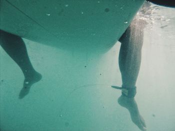 Low section of person surfing in sea