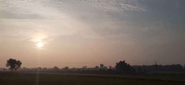 Scenic view of field against sky during sunset