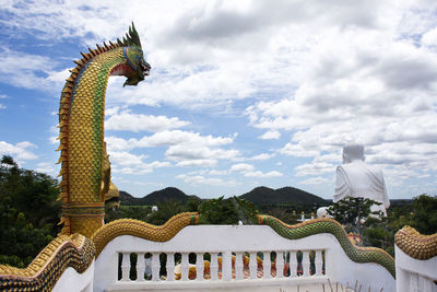 Statue of temple against building