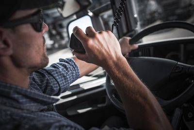 Man using walkie-talkie in truck
